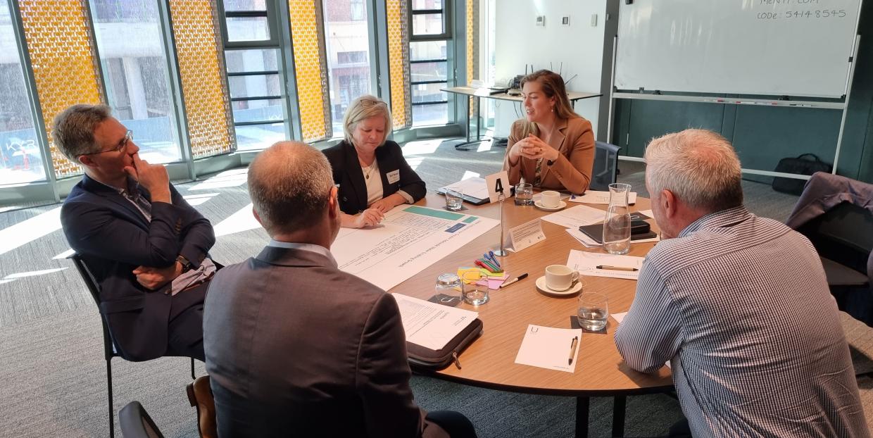 Professionals discussing documents around a table